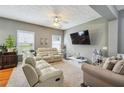 Relaxing living room featuring neutral walls, plush sofas, and a large TV at 2555 Flat Shoals Rd, South Fulton, GA 30349