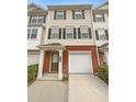 Beige three-story townhome with brick base and attached garage at 6756 Blackstone Pl # 6, Mableton, GA 30126