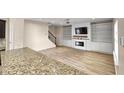 Living room with fireplace, built-in shelving, hardwood floors at 3203 Puritan Way, Mcdonough, GA 30252