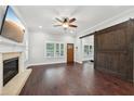 Living room with hardwood floors, fireplace, and barn door at 3483 Conley St, College Park, GA 30337