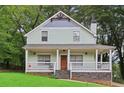 Charming light green two-story house with a porch at 3483 Conley St, College Park, GA 30337