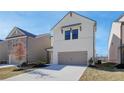 Two-story home with white siding, gray garage door, and landscaped yard at 4221 Portsbrook Ave, Snellville, GA 30039