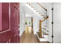 Bright entryway with hardwood floors, burgundy door and staircase at 1400 Village Creek Se Cir # 12A, Atlanta, GA 30316