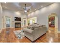 Spacious living room with hardwood floors, fireplace, and access to kitchen at 252 Madison Park Dr, Grayson, GA 30017