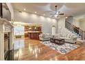 Open living room with hardwood floors, fireplace and staircase at 252 Madison Park Dr, Grayson, GA 30017