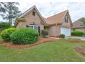 Brick home with landscaping, two-car garage and walkway at 252 Madison Park Dr, Grayson, GA 30017