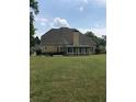 Back exterior of house with sunroom and large yard at 761 Hardage Farm Nw Dr, Marietta, GA 30064