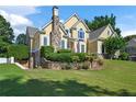 House exterior with stone accents and manicured lawn at 761 Hardage Farm Nw Dr, Marietta, GA 30064