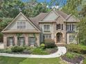 Two story house with stone accents and manicured lawn at 5180 Ivy Green Se Way, Mableton, GA 30126