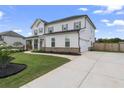 Two-story house with gray siding, brick accents, and a large driveway at 220 Arwen Dr, Mcdonough, GA 30253