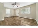 Living room with light walls, wood-look floors, and ceiling fan at 1743 Hollyhock Ter, Decatur, GA 30032