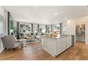 Open concept kitchen with island, hardwood floors, and stainless steel appliances at 967 Sutherland Lane(Lot 128), Lawrenceville, GA 30043
