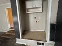 Small laundry room with washer and dryer hookups and upper cabinets at 6862 Old Beulah Rd, Lithia Springs, GA 30122