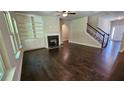 Living room with hardwood floors, built-in shelving, and a fireplace at 1147 Kingston Hill Dr, Loganville, GA 30052