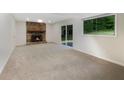 Spacious basement with neutral carpeting and a stone fireplace at 2140 Fern Valley Sw Dr, Atlanta, GA 30331