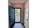 Inviting entryway with teal door and tile floor at 5432 Post Road Pass, Stone Mountain, GA 30088