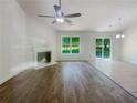 Living room with corner fireplace, hardwood floors, and sliding glass doors at 5233 Walnut Ct, Lithonia, GA 30038