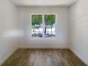 Bright bedroom with large window and wood-look flooring at 5233 Walnut Ct, Lithonia, GA 30038