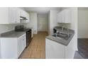 Spacious kitchen with white cabinets, stainless steel appliances, and tile flooring at 5233 Walnut Ct, Lithonia, GA 30038