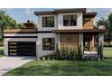 Modern two-story home with rooftop deck and black garage door at 512 Fortner Ln, Atlanta, GA 30349