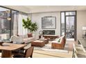 Spacious living room with hardwood floors, large windows, fireplace, and city view at 40 12Th Ne St # 1005, Atlanta, GA 30309
