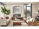 Living room features hardwood floors, a fireplace and large windows with city views at 40 12Th Ne St # 1005, Atlanta, GA 30309