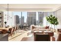 Open concept living and dining area with hardwood floors and floor to ceiling windows at 40 12Th Ne St # 1005, Atlanta, GA 30309