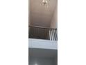 Elegant staircase with a wrought iron railing and wood accents at 6093 Ruby Falls Way, Stonecrest, GA 30038