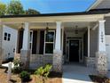 Inviting front porch with stone details at 1084 Cooks Farm, (Lot 30) Way, Woodstock, GA 30189