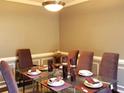 Formal dining room with glass table, purple chairs, and wainscoting at 2530 Zane Sw Dr, Atlanta, GA 30331