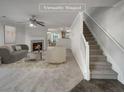 Virtually staged living room with fireplace and staircase at 6531 Arbor Gate Sw Dr # 12, Mableton, GA 30126