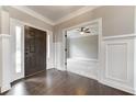 Two-story foyer with hardwood floors and wainscoting at 6175 Grindle Rd, Cumming, GA 30041