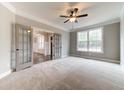 Bright office with French doors, carpet, and large window at 6175 Grindle Rd, Cumming, GA 30041
