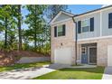 Front view of a two-story townhome at 7041 Livia Pt, Riverdale, GA 30296