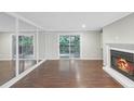 Living room with hardwood floors, fireplace, and mirrored wall at 707 Cumberland Se Ct, Smyrna, GA 30080