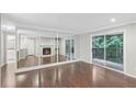 Living room with hardwood floors, fireplace, and mirrored wall at 707 Cumberland Se Ct, Smyrna, GA 30080