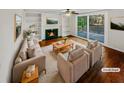 Virtually staged living room with hardwood floors, fireplace, and built-in shelves at 120 Blackberry Run, Fayetteville, GA 30214