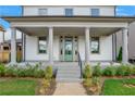 Front porch with columns, steps, and landscaping at 1356 Flora Dr, Conyers, GA 30094