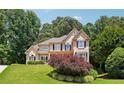 Two-story home with stone accents and landscaping at 6925 Keswick Ct, Cumming, GA 30040