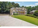 Two-story home with stone accents and landscaping at 6925 Keswick Ct, Cumming, GA 30040