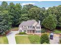Two-story home with stone accents and landscaping at 6925 Keswick Ct, Cumming, GA 30040