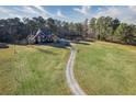 Aerial view of a two-story red brick house with a long driveway at 1601 Ebenezer Rd, Conyers, GA 30094