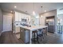 Modern kitchen with white cabinets, quartz island, and stainless steel appliances at 1725 Prospect Way, Conyers, GA 30094