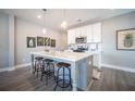 Modern kitchen with white cabinets, quartz island, and stainless steel appliances at 1725 Prospect Way, Conyers, GA 30094