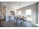 Bright dining room with wood table, gray chairs, and large windows at 1725 Prospect Way, Conyers, GA 30094