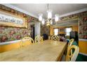 Dining room with floral wallpaper and light wood table at 3152 Hardin Ct, Lithonia, GA 30038