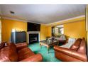 Living room with fireplace and brown leather couches at 3152 Hardin Ct, Lithonia, GA 30038