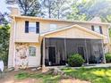 Front view of a two-story house with a screened porch at 1225 Creek Forest Nw Ct, Conyers, GA 30012