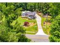 Spacious house with a large backyard and a long driveway, surrounded by lush greenery at 84 Ledbetter Rd, Villa Rica, GA 30180