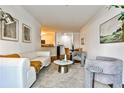 Open concept living room flows into kitchen and dining areas, featuring hardwood floors at 3334 Peachtree Ne Rd # 704, Atlanta, GA 30326